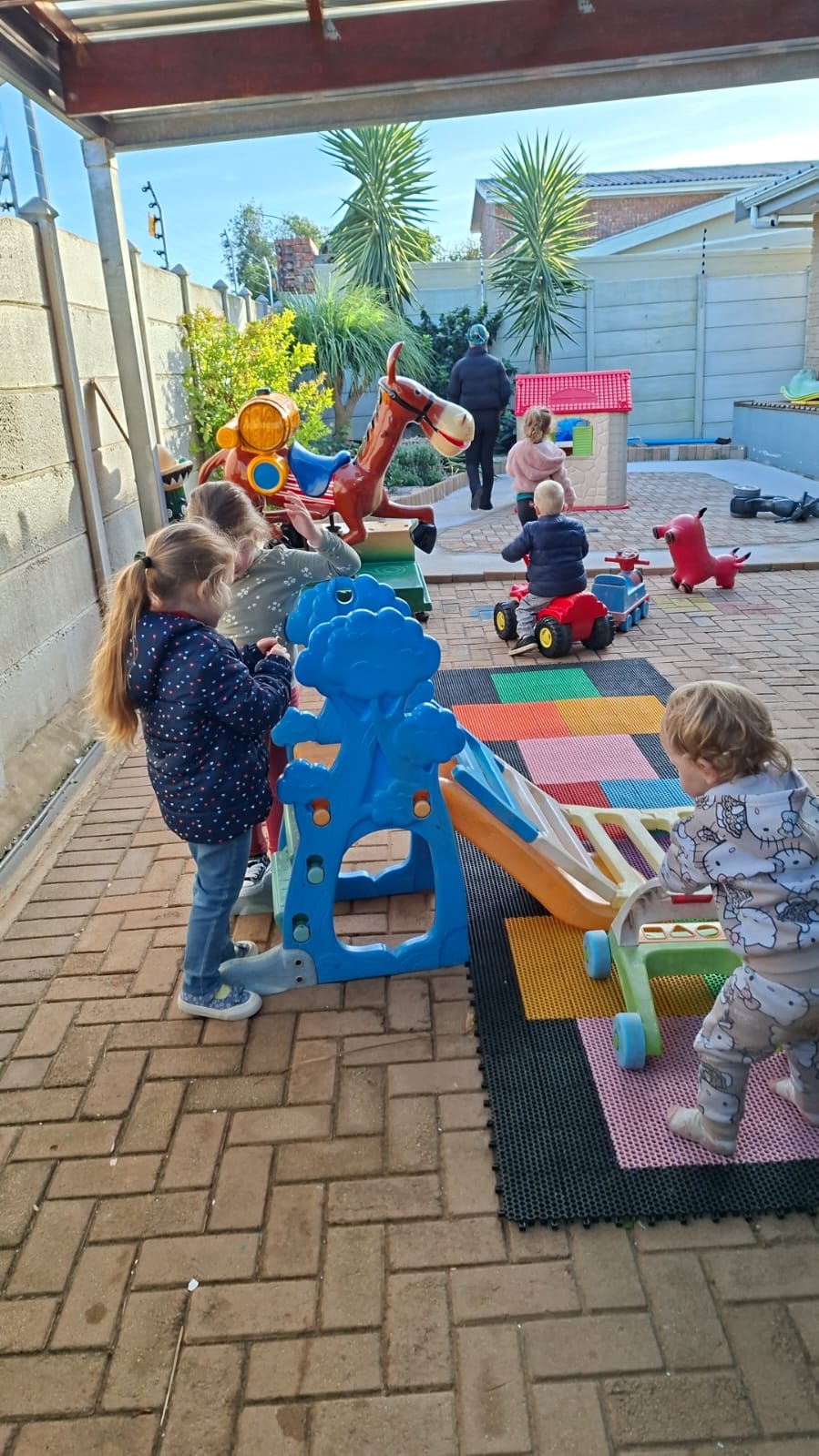 Children playing outside on ride-ons