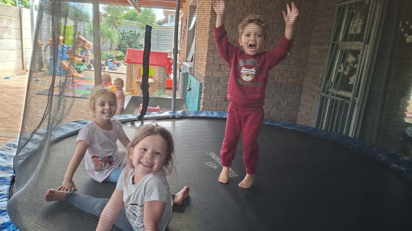 Happy children playing and learning in a bright, warm preschool classroom